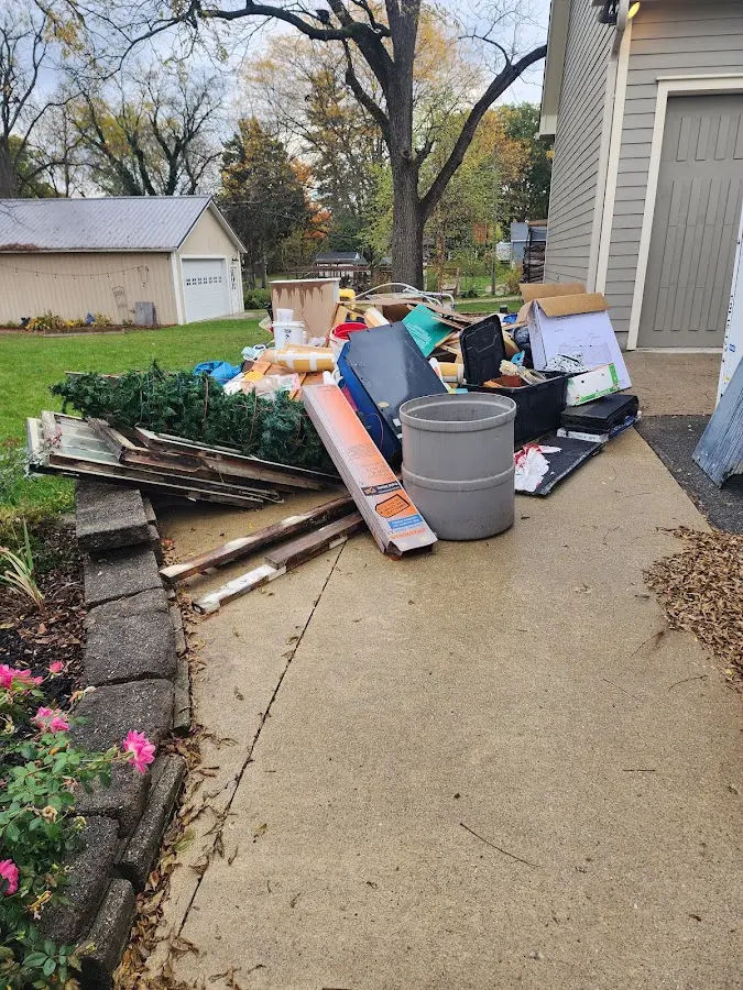 Dumpster being loaded with debris for Estate Cleanout Dumpster Rental in Lee Acres